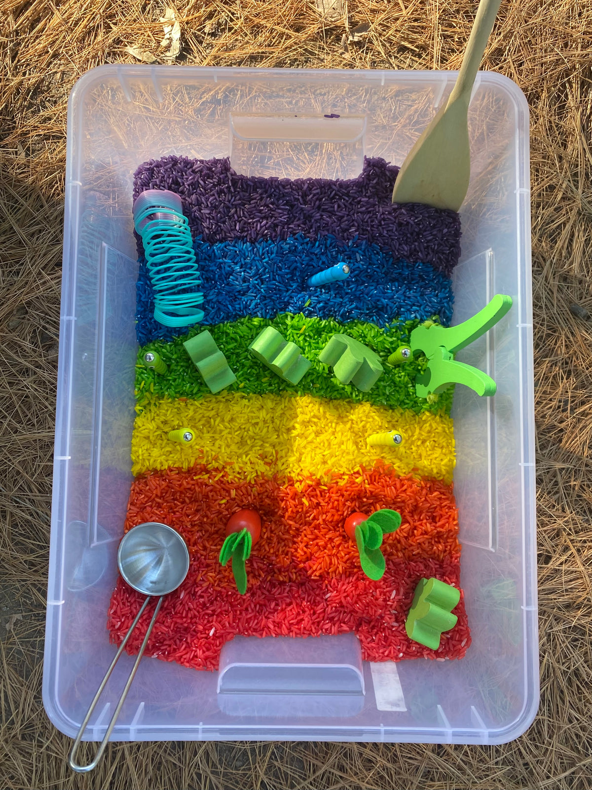 Rainbow sensory play bin with coloured rice for little ones