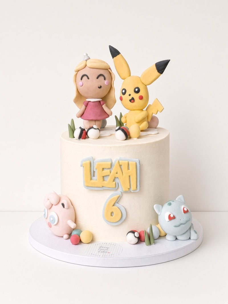 Handmade fondant cartoon figures on a 6th birthday cake