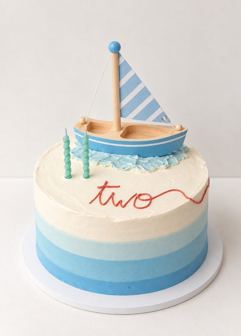 Fondant sailboat on a blue ombre cake