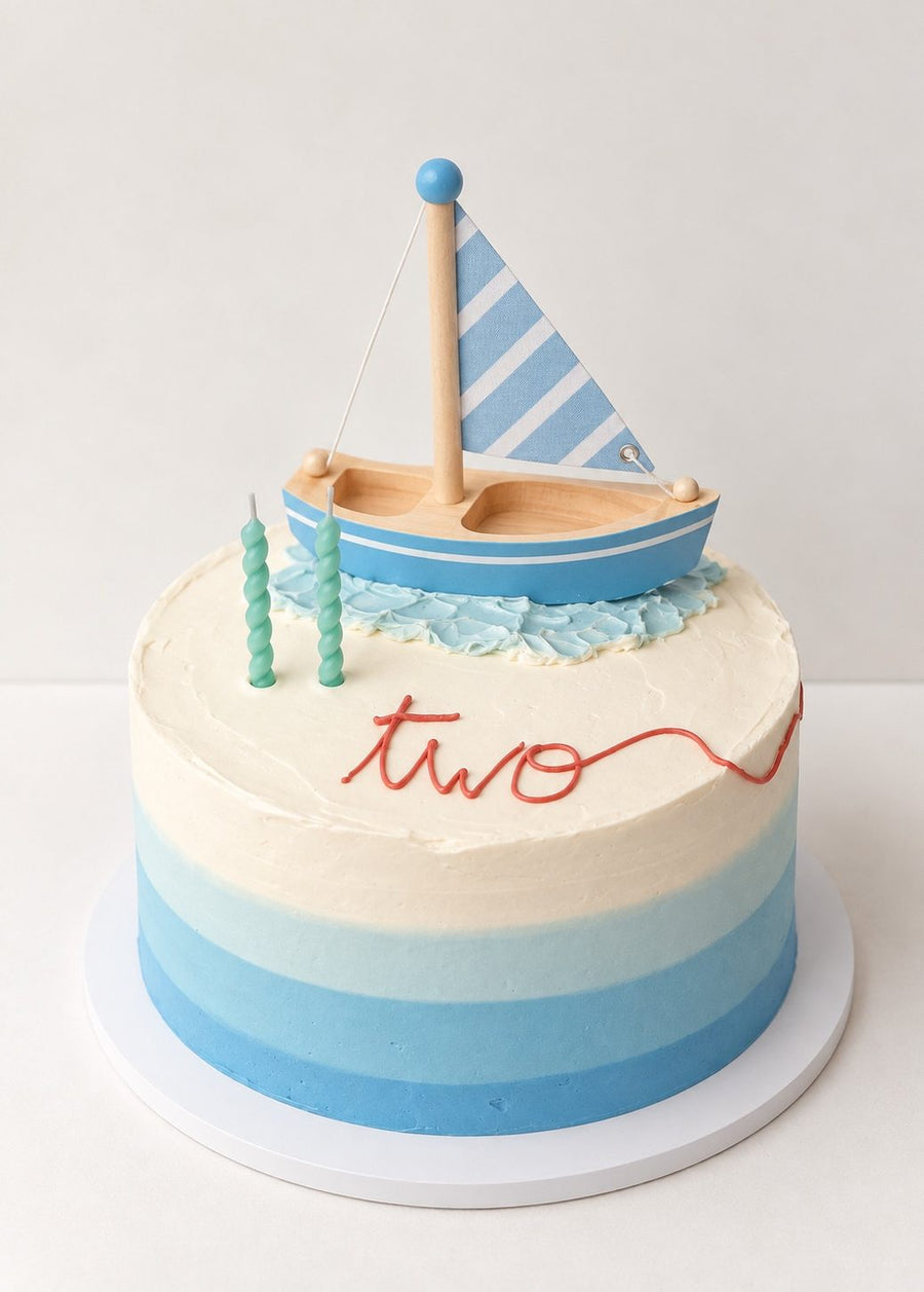 Blue ombre cake with a fondant sailboat
