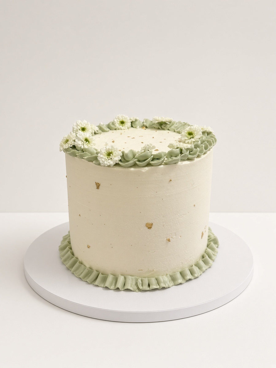 Ivory cake with sage piped daisies